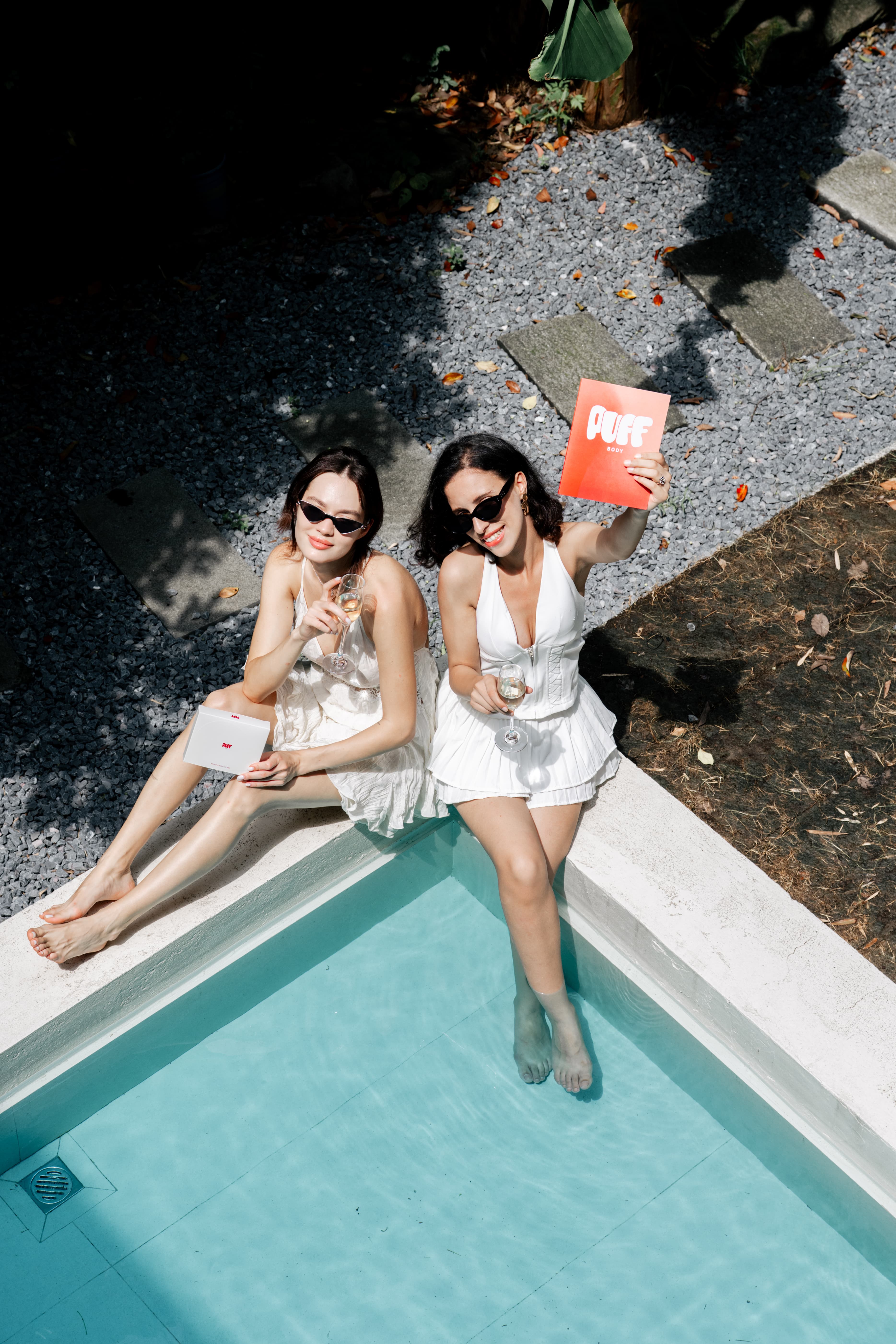 Two PUFF creators enjoying a poolside celebration